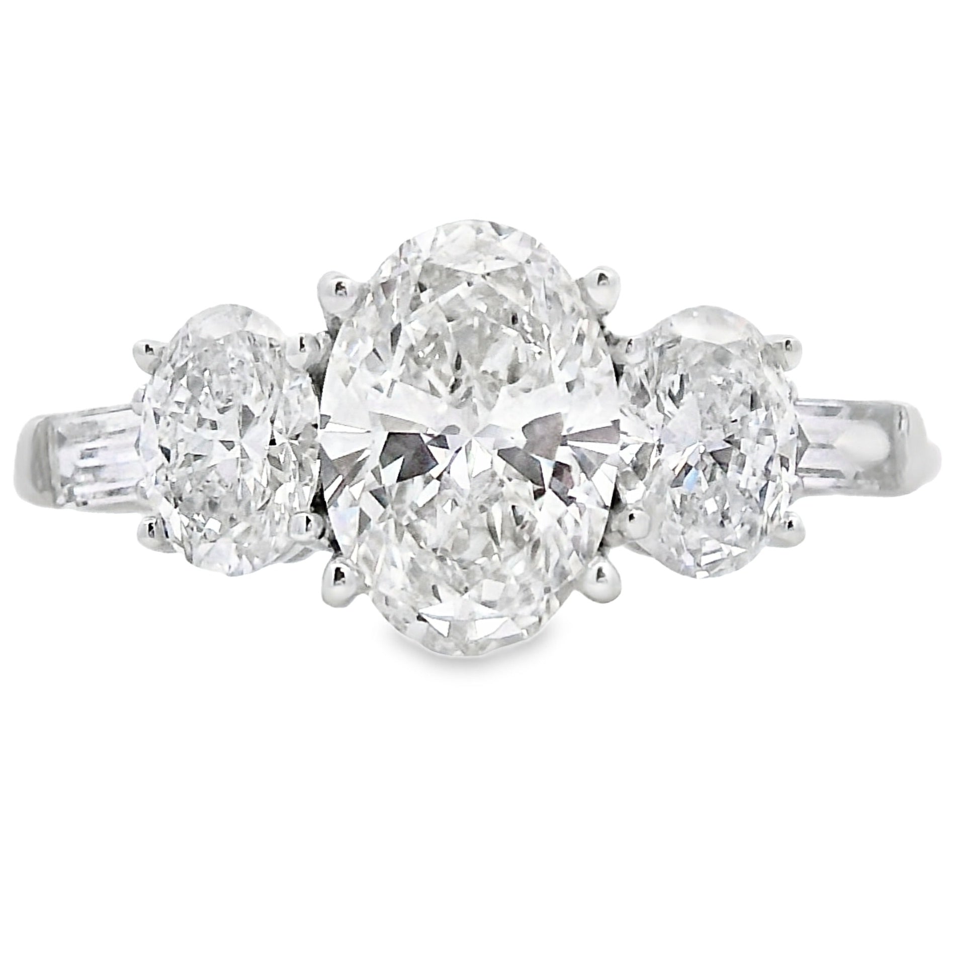 Diamond ring with three stones on a white background