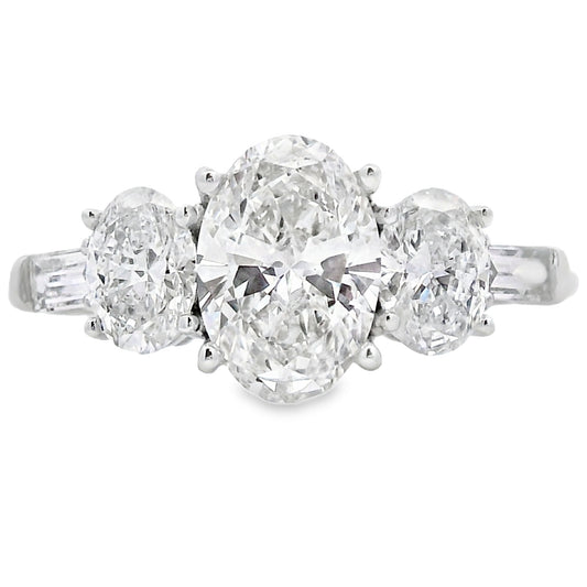 Diamond ring with three stones on a white background