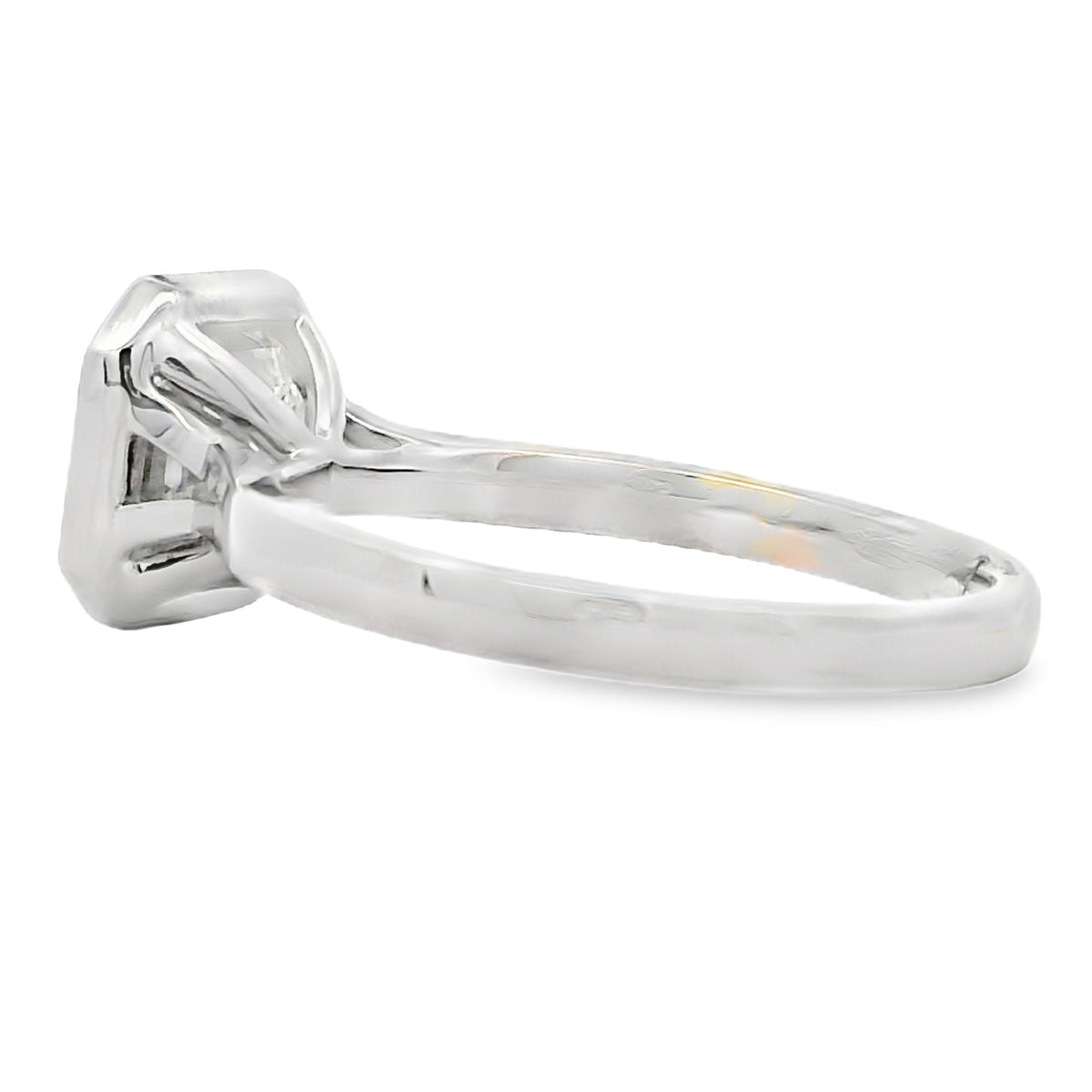 A silver-toned diamond engagement ring with a bezel-set diamond and a polished band, shown from a side profile view on a white background.