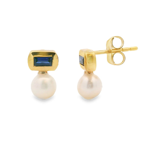 Lab-created sapphire and freshwater pearl stud earrings in gold plated sterling silver, front and side view showing baguette sapphire above white pearl