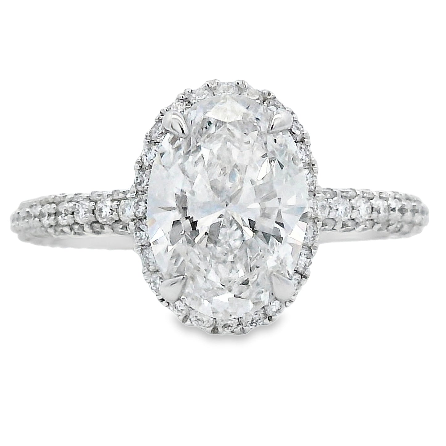 Diamond ring with a large central gemstone and smaller stones around on a white background