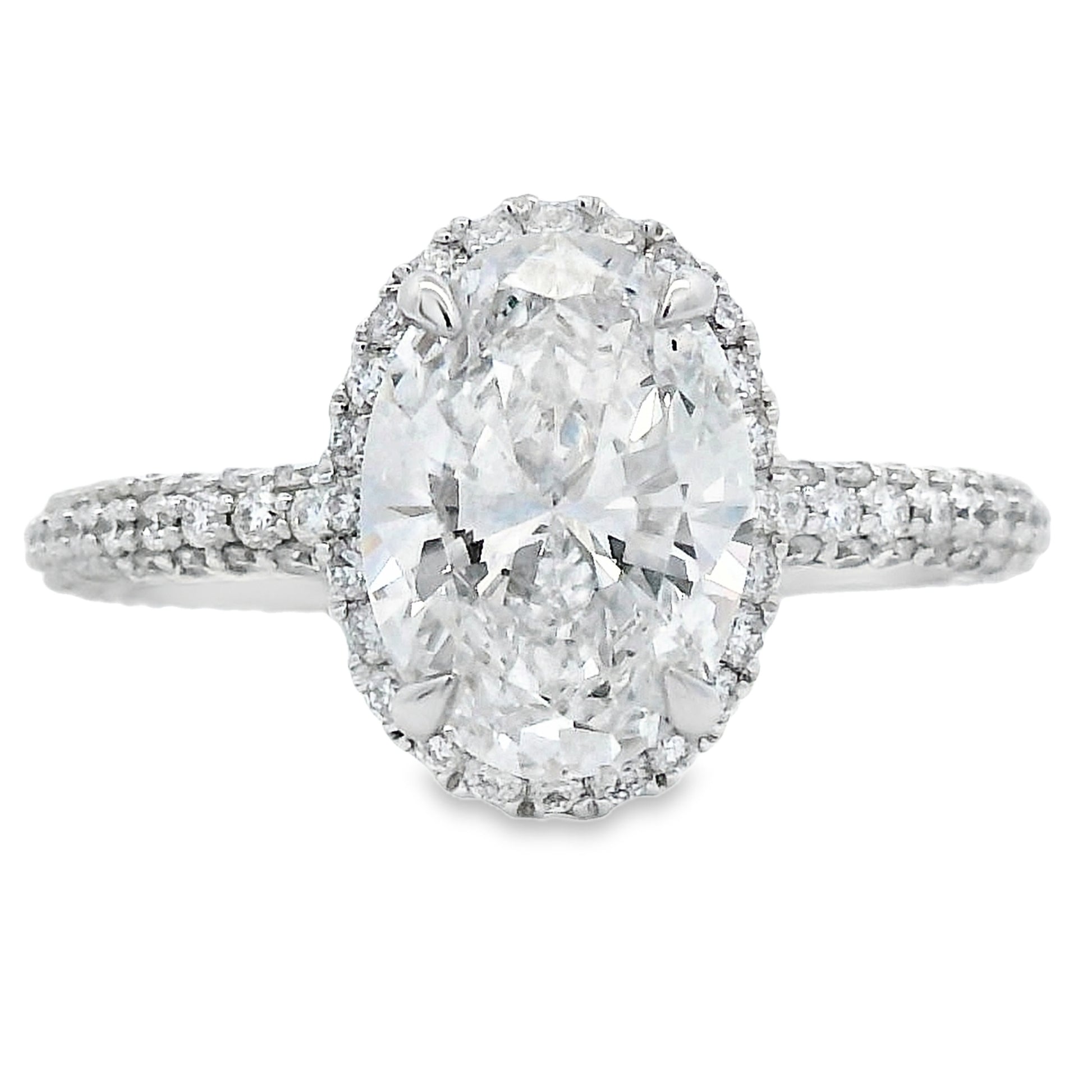 Diamond ring with a large central gemstone and smaller stones around on a white background