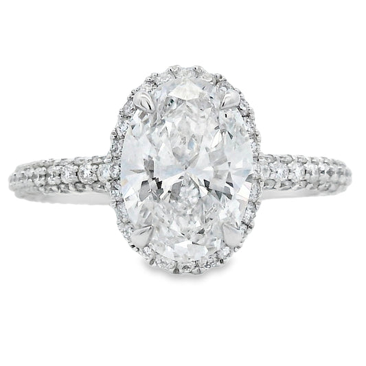 Diamond ring with a large central gemstone and smaller stones around on a white background